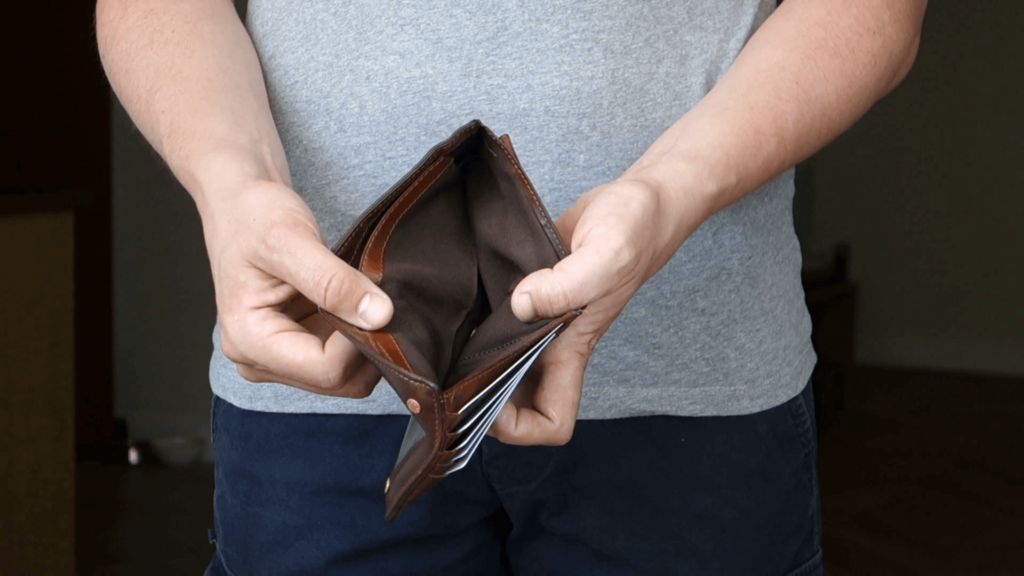 a man showing an empty purse