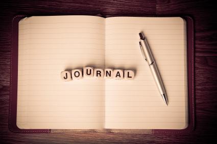 a notebook with journal blocks and a pen