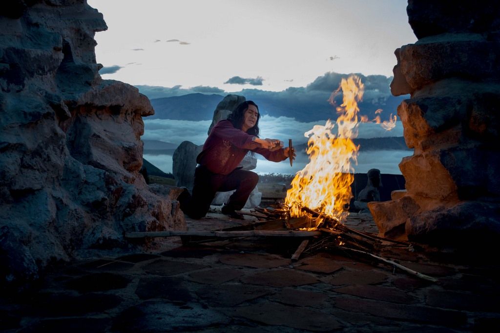 A Human Trying To Survive By Burning Wood