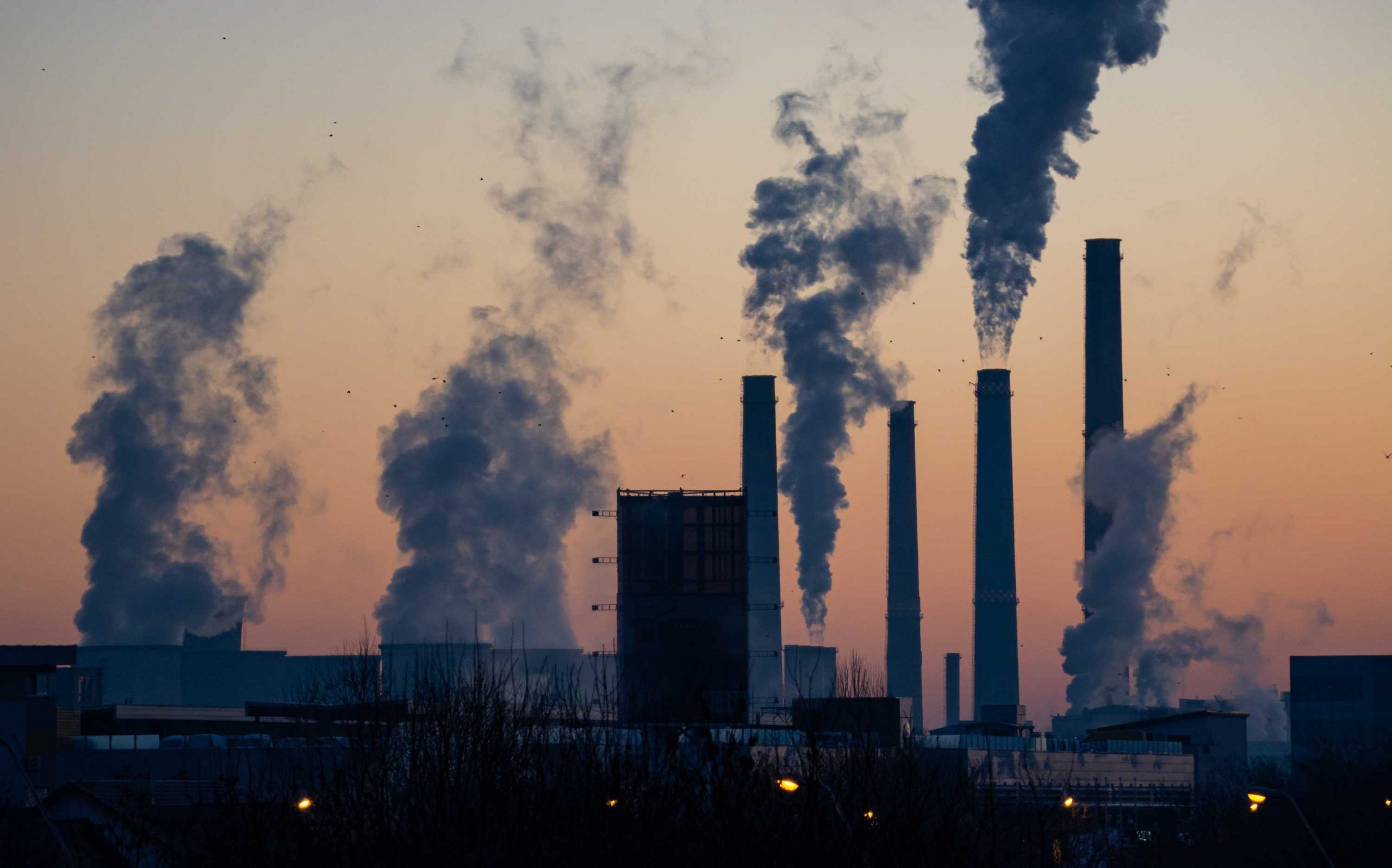 Factory Buildings With Black Smoke Coming Out From Chimneys